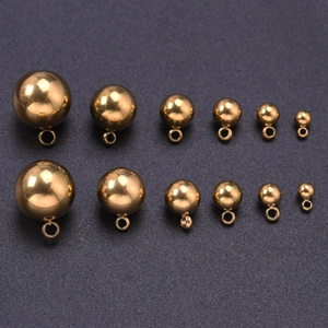 Détail de pendentifs sphériques en acier inoxydable doré de tailles variées