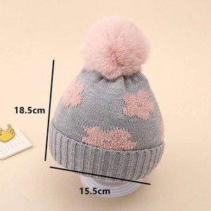 Detailed size measurement of baby knitted hat with pink floral pattern and plush pom pom