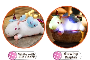 Detailed view of the glowing plush unicorn pillow in white color with blue heart wings