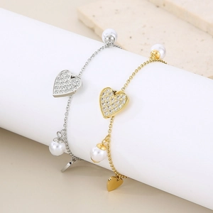 Detail view of heart-shaped diamond necklaces and pearl bracelets in gold and silver finish