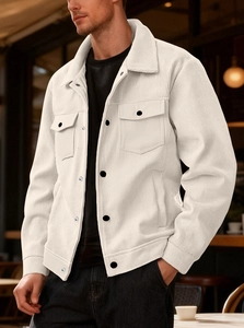 Detail of men's cream corduroy jacket showing classic collar and black buttons