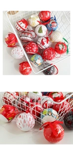 Detail of Christmas tinplate balls with festive patterns and Merry Christmas text