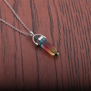 Detailed shot of double-pointed hexagonal gemstone pendant with a gradient color effect