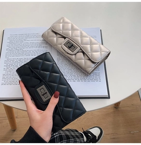 Detailed macro of quilted long wallets with vintage metal locks on a magazine background