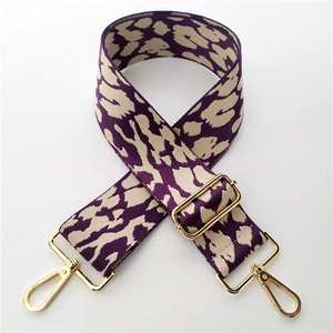 Detail of 5cm wide leopard jacquard bag strap with gold metal swivel lobster clasps