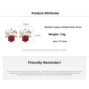 Detail view of red hexagonal zircon earrings with white imitation pearls and copper base