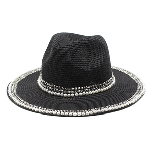 Detail of the black woven straw fedora hat featuring elegant pearl and rhinestone trim