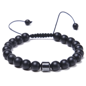 Detail of 8mm matte black beads and silver metallic charm on adjustable braided bracelet