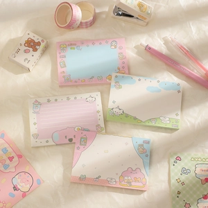 Flat lay of cute cartoon bear and bunny non-sticky note pads in pastel macaron colors