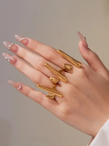 Detailed view of 18k gold plated stainless steel organic lava style rings on hand