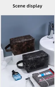Detail of waterproof PU leather toiletry bags in brown and charcoal with marble texture