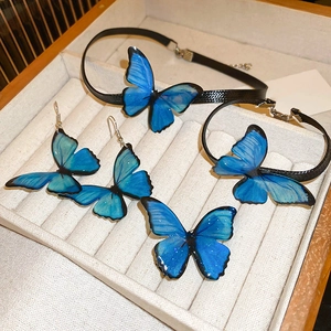 Detail of blue gradient butterfly jewelry set including necklace, bracelet and earrings