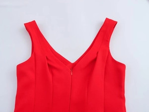 Detail of red V-neck sleeveless dress with front invisible zipper and textured fabric