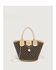 Detail view of bucket bag featuring vintage patterns, gold chain, and pearl pendant charm