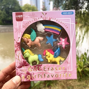 Close-up of unicorn and rainbow shaped eraser set in pink gift packaging