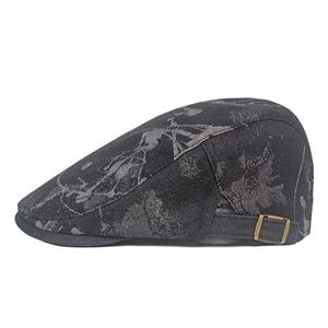 Detail of adjustable brass buckle and floral jacquard texture on vintage flat cap
