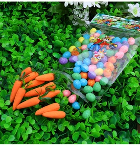 Close-up of sparkling colorful Easter eggs and orange carrots with green leaves decor