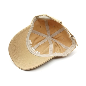 Detail view of khaki cotton baseball cap interior showing six-panel stitching and sweatband