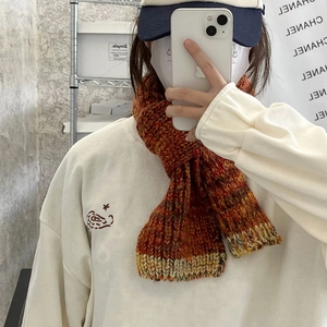 Detailed close-up of retro knit scarf with soft multi-color blended yarn texture