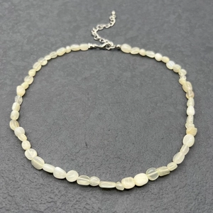 Detail of irregular natural cream stone beads with stainless steel lobster clasp and chain