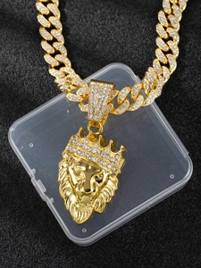 Close-up of golden lion head pendant with rhinestone crown on iced out Cuban chain