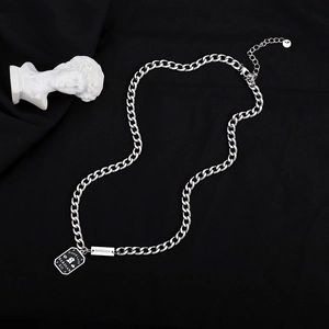 Silver cuban chain necklace with Good Luck rectangular pendant and bar tag on black cloth