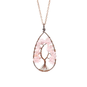Detail of copper wire-wrapped tree of life pendant with pink quartz stones
