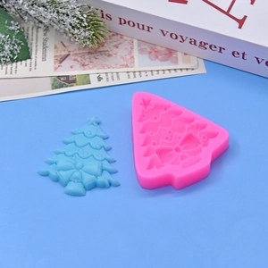 Detailed silicone mold for Christmas tree cake topper with textured layers and bow