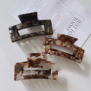 Three acetate hollow rectangular hair claws in marble and tortoiseshell patterns for women