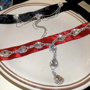 Gros plan de colliers ras de cou en velours avec franges en cristal et zircons