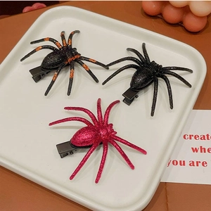 Three glittery spider hair clips in black, orange, and pink for Halloween hair styling