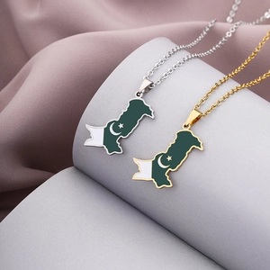 Detailed close-up of gold and silver Pakistan map necklaces with enamel flag patterns