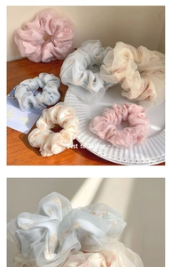 Macro view of organza scrunchies with delicate floral prints in pastel macaron colors