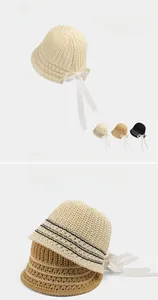 Detailed knit texture of breathable hollow bucket hat with elegant lace ribbons