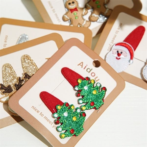 Detail of Christmas hair clips featuring embroidered reindeer and snowman on display cards