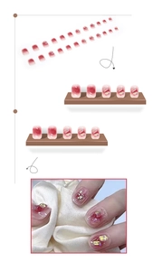 Close-up of red ombre press-on nails with 3D rhinestones and gems detail layout