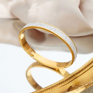 Elegant gold-plated stainless steel open bangle with shimmering pave-set white zircons