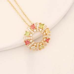 Macro detail of gold flower pendant necklace with colorful cubic zirconia inlays