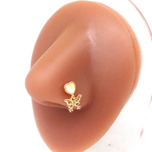 Golden heart-shaped nose stud with butterfly dangle and crystals on a realistic model