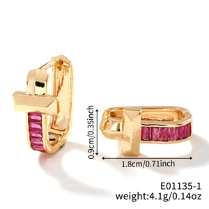 Detail of gold U-shaped cross earrings with pink crystals and dimension markings