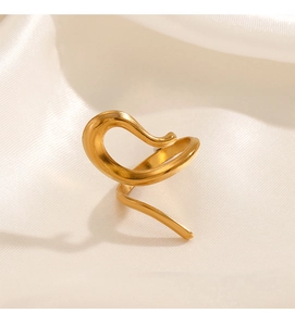 Detailed view of abstract gold-plated geometric ring on ivory silk fabric background