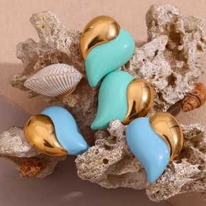 Detail of heart earrings with mint green and blue enamel on 18K gold plated steel
