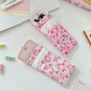 Detailed view of quilted floral glasses pouches with lace trim and polka dot lining