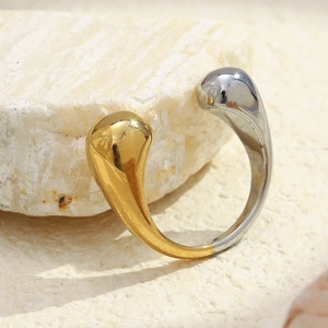 Minimalist teardrop shaped dual-tone ring in gold and silver finish on stone