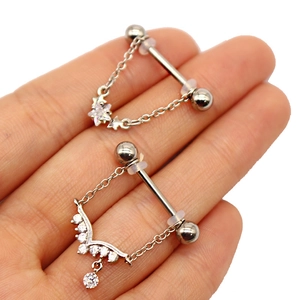 Detailed view of silver nipple rings with star charms and sparkling zircon crystals