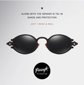 Detail of black steampunk sunglasses featuring red floral carvings and cross accents