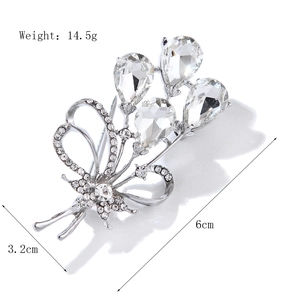 Elegant silver bow and balloon crystal brooch with size markers for shirt and dress