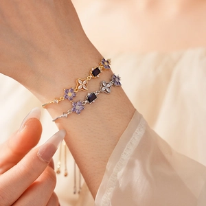 Close-up of adjustable bracelets with purple zircon flowers and blue rectangular stones