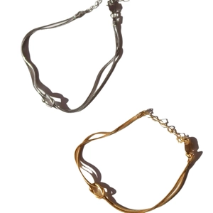 Gold and silver stainless steel snake chain bracelets with center knot design