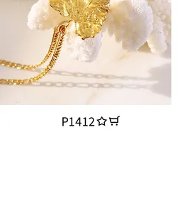 Macro shot of a golden leaf pendant with detailed veins on a fine Figaro chain